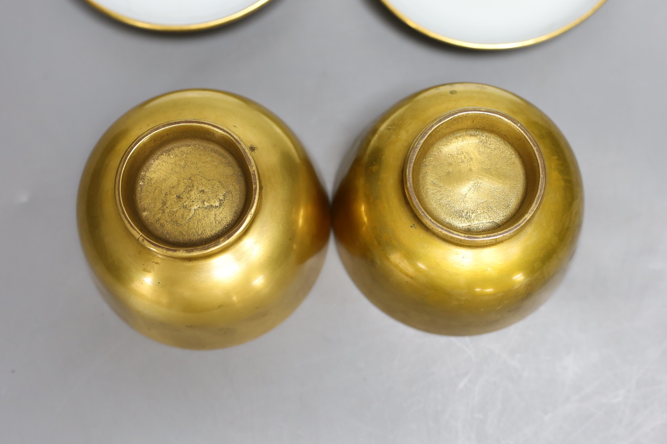 A pair of Paris porcelain gilded tea bowls and saucers , first half of 19th century, saucer 13cms diameter